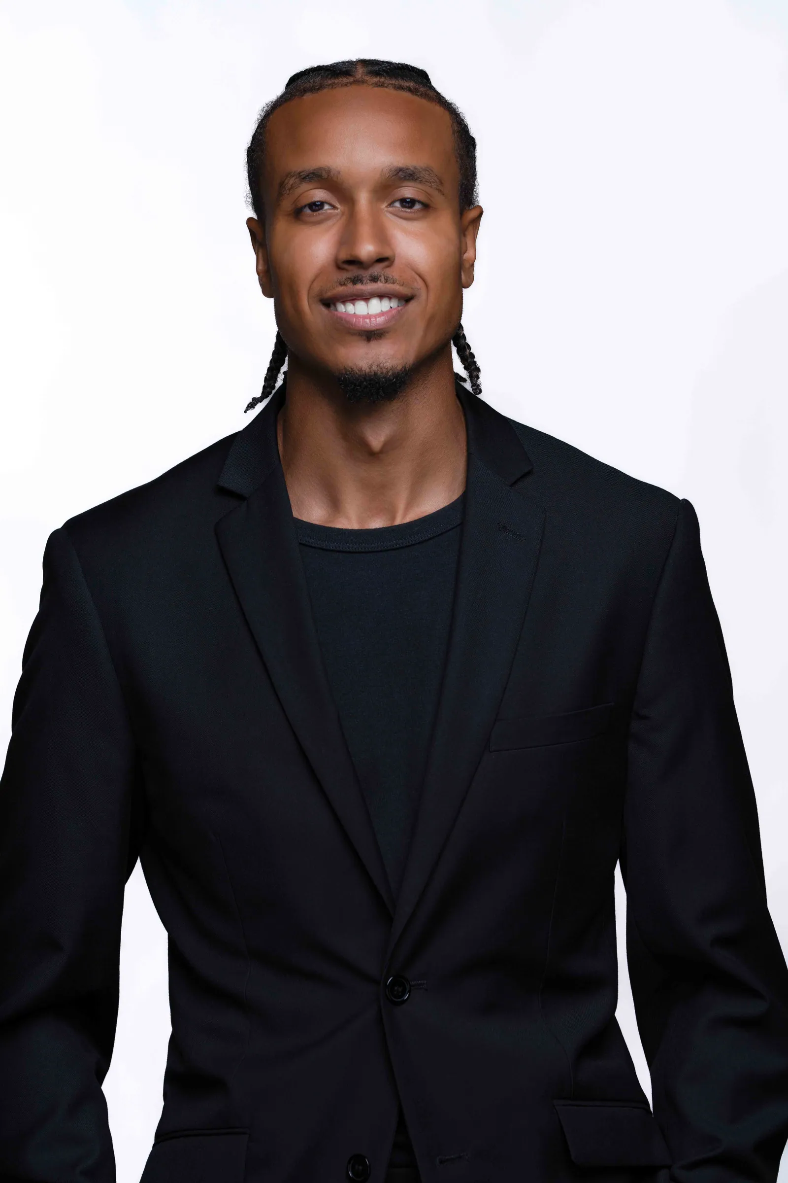Brandon S. Welch, photographed against a white field in a black jacket.