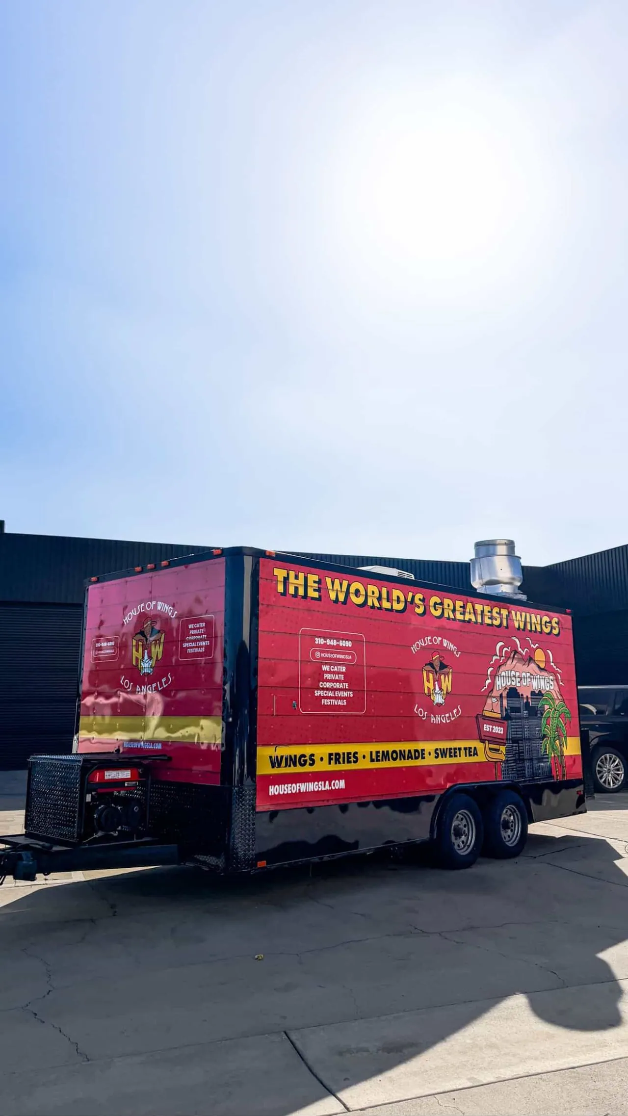 Rear three quarter of the trailer, showing the full wrap wrapping the corner and the catering details panel.