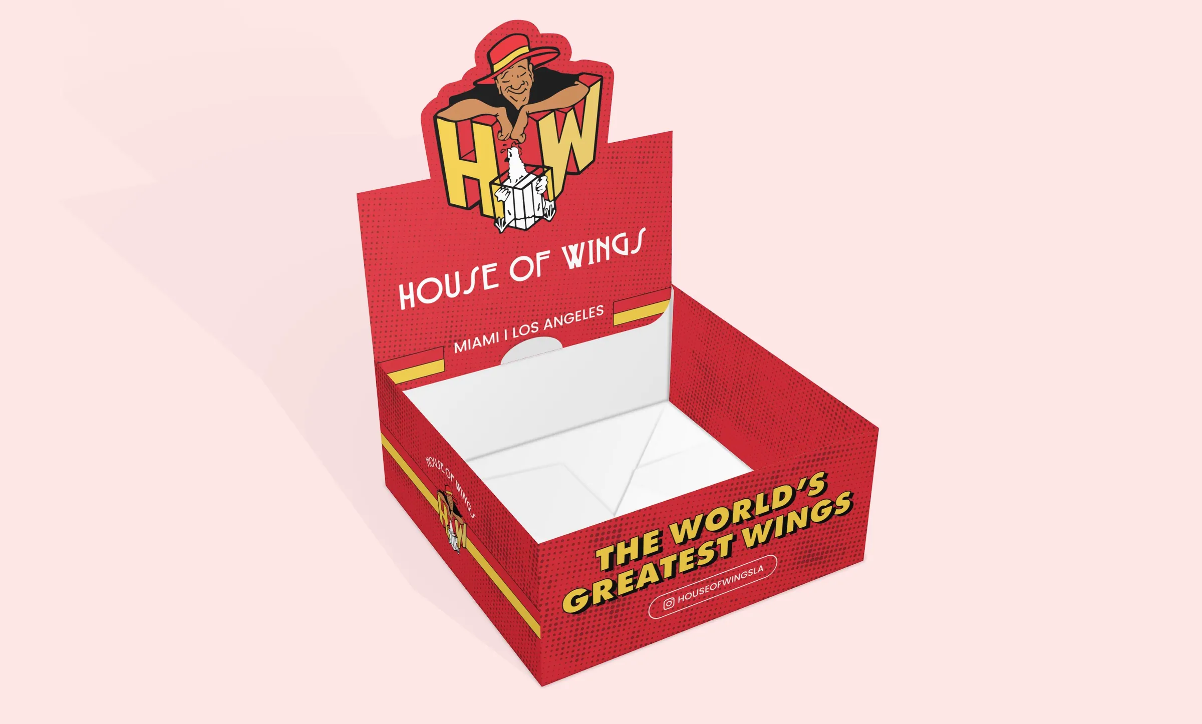 Retail display box. The mark and the world’s greatest wings line carried onto packaging in the same red, yellow and halftone system.