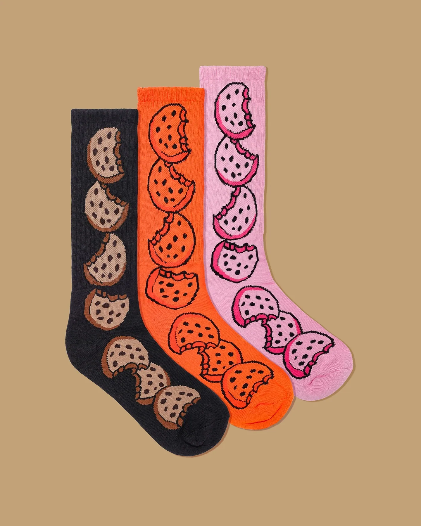 The Original Cookie Sock Pack in black, orange and pink, each colourway knit with the same bitten cookie repeat.
