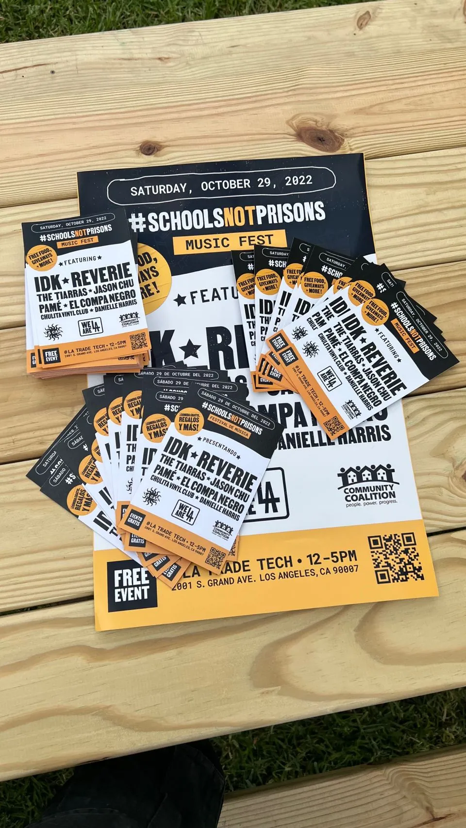 Printed handbills and posters for the music fest, stacked on a bench at the venue.